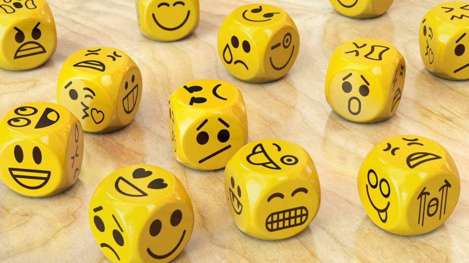 Autismo e as emoções: dadinhos amarelos com carinhas representando nossas emoções.