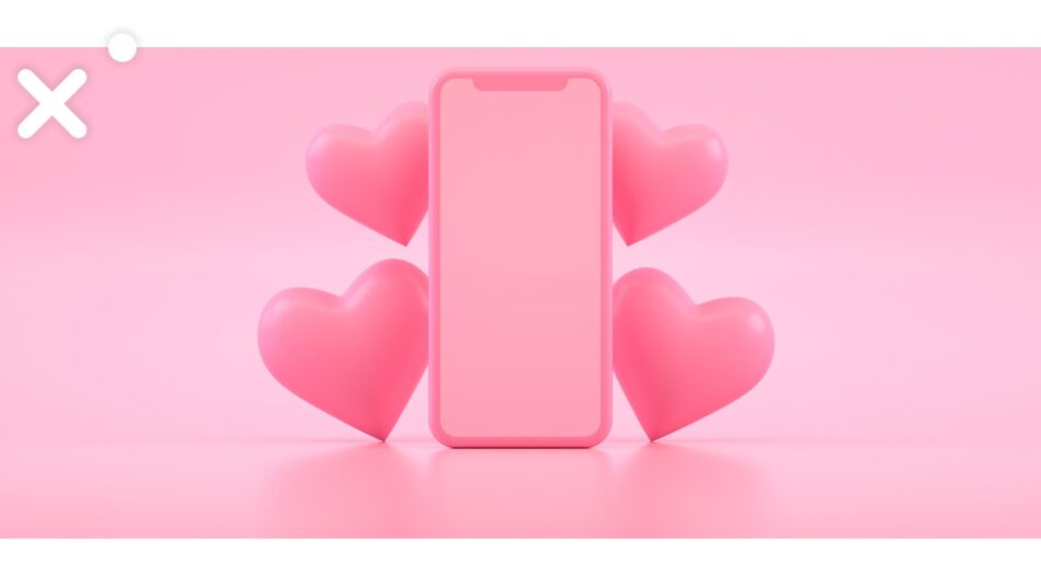 Foto com fundo rosa claro, ao centro, um celular e apoiados nele, dois corações de cada lado. Ilustra o texto Geração Z em perigo.